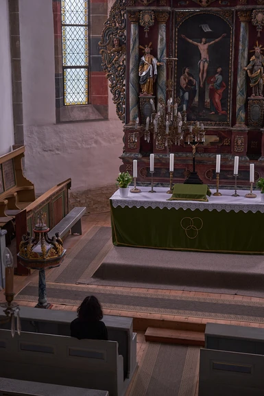 Person praying inside the Cistercian Abbey from Cârța