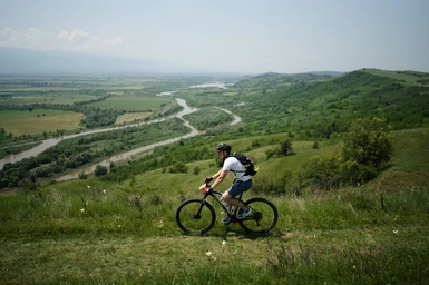 Bike uphill in a nice field with the river in the background.